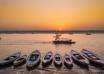 Varanasi ghats lit with rows of earthen diyas along the Ganga at dusk