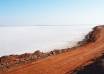 Road running through the white salt desert of the Rann of Kutch near Dholavira