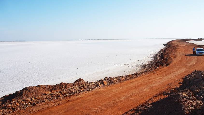 Road running through the white salt desert of the Rann of Kutch near Dholavira